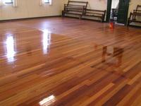 Timber floors during treatment - This timber floor is having the first coat applied in a community hall.&nbsp;
The floor was only one year old and was heavily worn due to very high traffic. Using a sealer is a one day process, with no smells or sanding required.