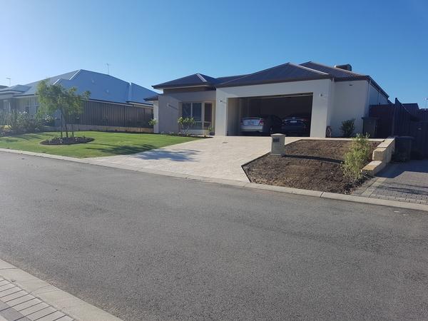 Shrubs and other plants are removed and the soil has been leveled out for a windsor green couch lawn to be laid in Banksia Grove