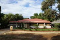 After 3 - the front of this property was totally transformed with a total clean up and a number of plants that were transplanted and are still surviving. Synthetic lawn was placed in the centre of the area and a row of oleanders were planted as a front hedge and a row of pittosporum down the side of the property. The veranda was enclosed with a lattice work frame and painted to match the house. All the garden beds had weed mat laid so it encouraged a very low maintenance garden for the future. Also all the plants have&nbsp;a fully automated dripper system.