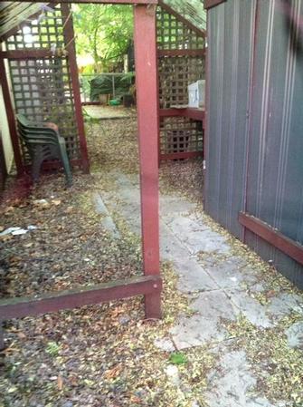 Court Yard tidy in Hawthorn East before shot - Believe it or not, there is actualy a path way with pavers and some river pebbles on the side. The build up of leaves here was massive! it hadn&#39;t been touch in so long...